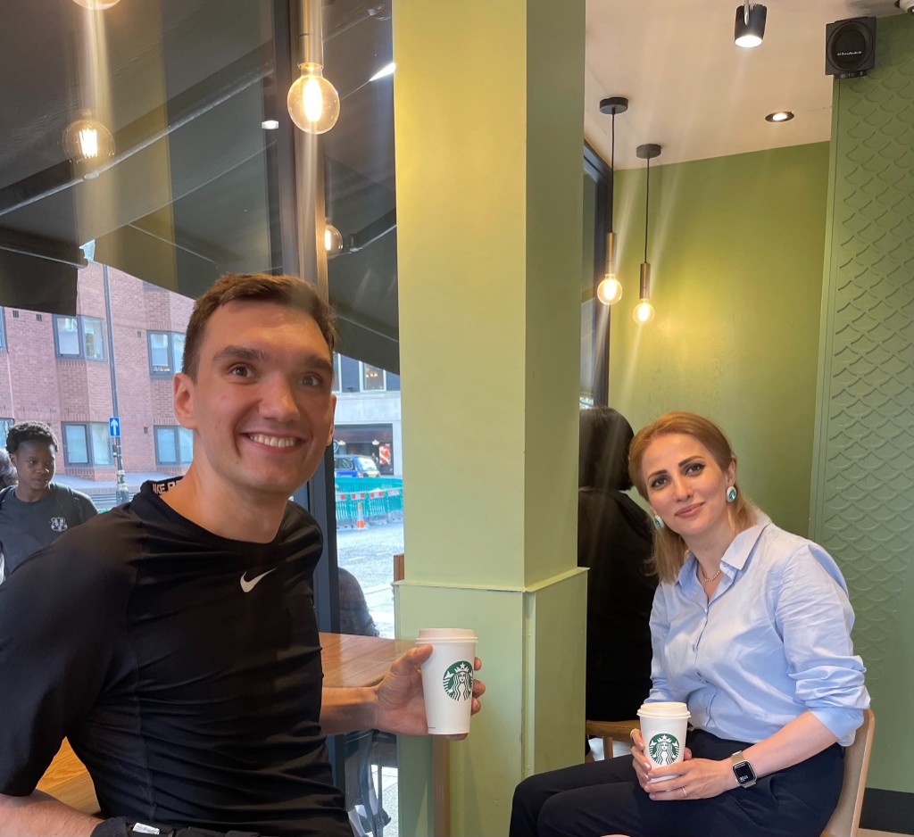 Samira and Viktor at Starbucks at the end of a long day of meetings
